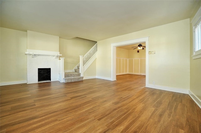 unfurnished living room with hardwood / wood-style flooring and ceiling fan