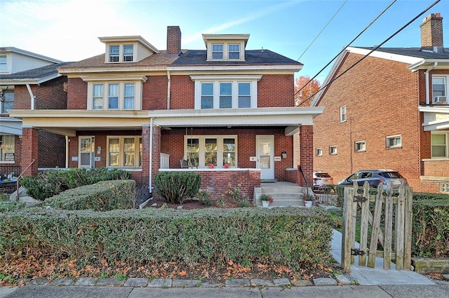 townhome / multi-family property featuring covered porch