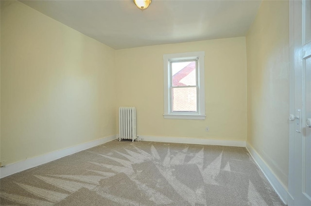 carpeted spare room featuring radiator heating unit