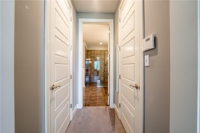 hall with light colored carpet