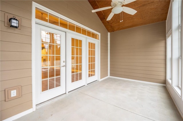 unfurnished sunroom with ceiling fan, french doors, plenty of natural light, lofted ceiling, and wood ceiling