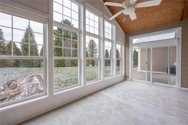 unfurnished sunroom featuring ceiling fan, wood ceiling, and vaulted ceiling