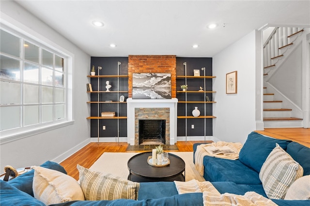 living room with wood-type flooring and a fireplace