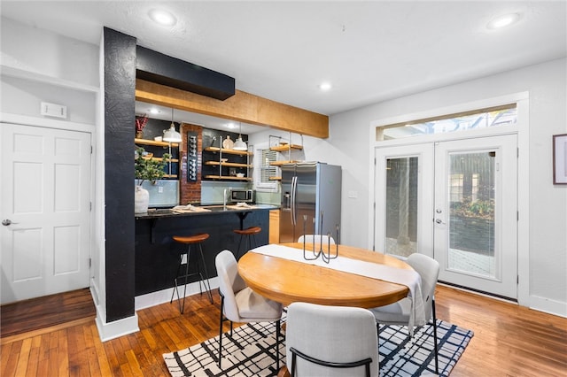 dining area featuring french doors and light hardwood / wood-style flooring