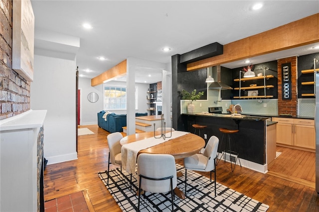 dining space featuring hardwood / wood-style flooring and sink