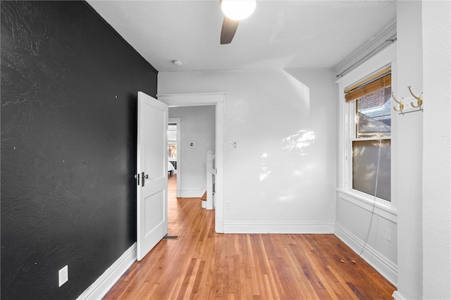 spare room featuring light hardwood / wood-style flooring and ceiling fan