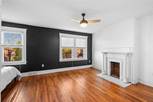 unfurnished living room featuring ceiling fan and hardwood / wood-style floors