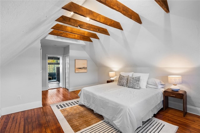 bedroom with hardwood / wood-style flooring and lofted ceiling with beams