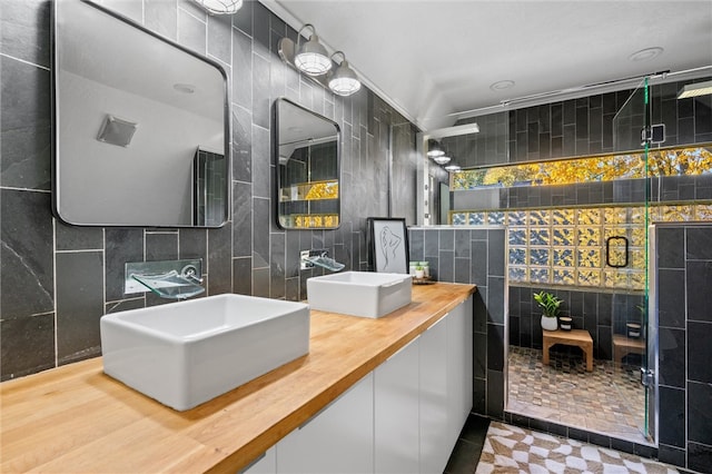 bathroom featuring vanity, tile walls, a shower, and tile patterned floors