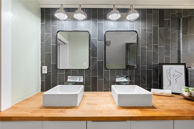 bathroom featuring vanity and decorative backsplash