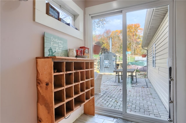 doorway featuring light tile patterned flooring