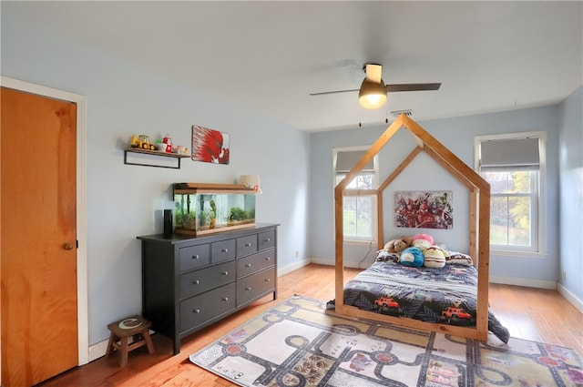 bedroom featuring light wood-type flooring and ceiling fan