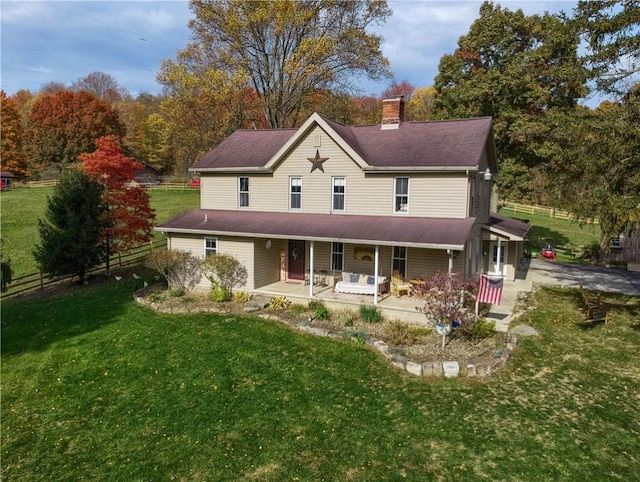 view of front of property with a front yard and covered porch