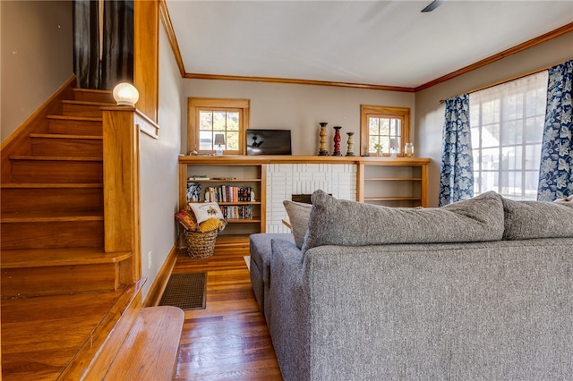 living room featuring a wealth of natural light, wood-type flooring, and crown molding