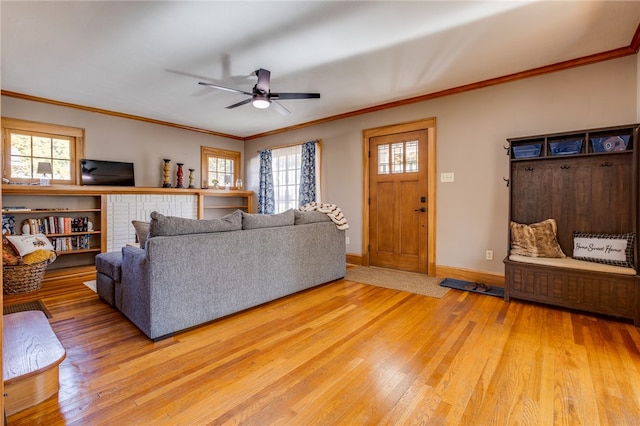 living room with ceiling fan, wood-type flooring, and ornamental molding