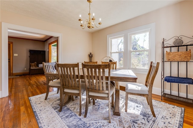 dining room featuring dark wood-type flooring and an inviting chandelier