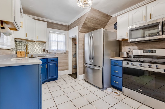 kitchen with tasteful backsplash, stainless steel appliances, light tile patterned floors, white cabinets, and blue cabinets