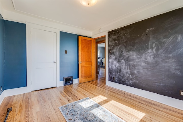 unfurnished bedroom featuring light wood-type flooring