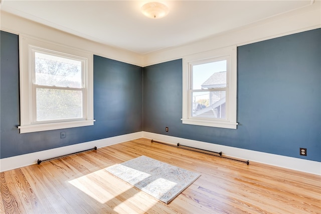 unfurnished room with light wood-type flooring