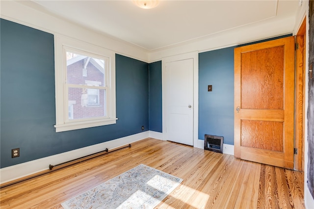 bedroom with a closet and light hardwood / wood-style flooring