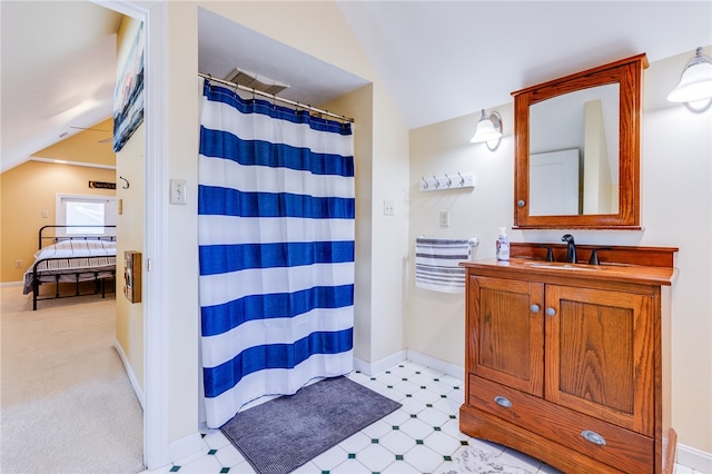 bathroom with vanity and vaulted ceiling