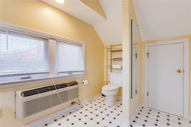 bathroom with toilet and lofted ceiling