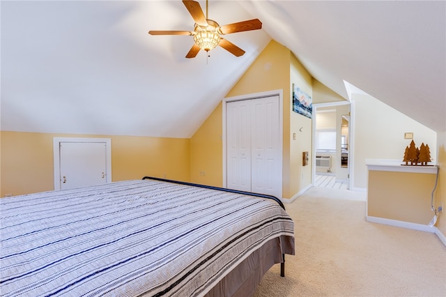 bedroom with ceiling fan, a closet, vaulted ceiling, and light colored carpet