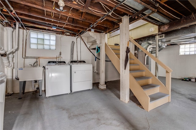 basement featuring separate washer and dryer and sink