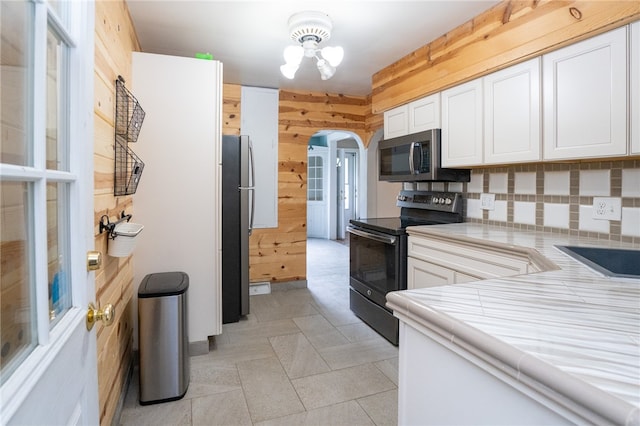 kitchen featuring white cabinetry, tasteful backsplash, and stainless steel appliances