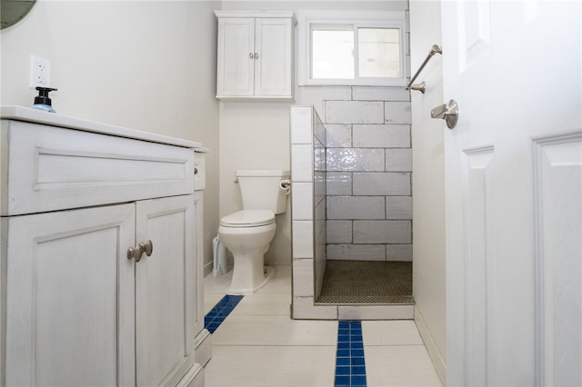 bathroom with toilet, vanity, a shower, and tile patterned flooring