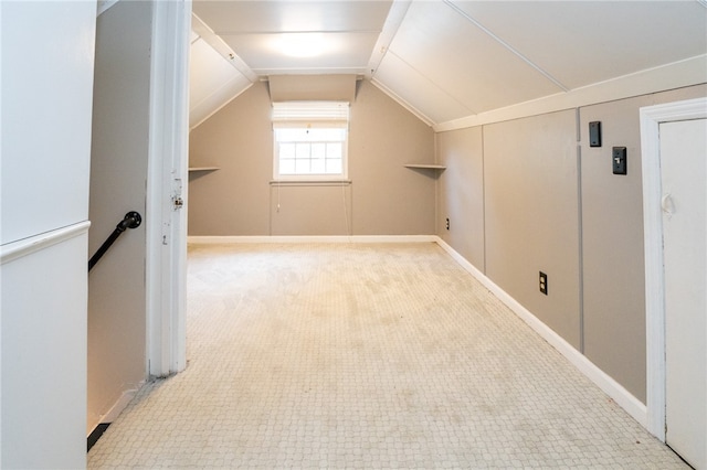 additional living space featuring light carpet and lofted ceiling