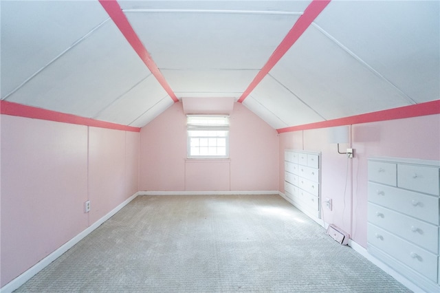 additional living space with vaulted ceiling and light colored carpet