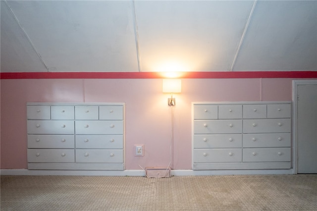 additional living space with vaulted ceiling, mail boxes, and light colored carpet