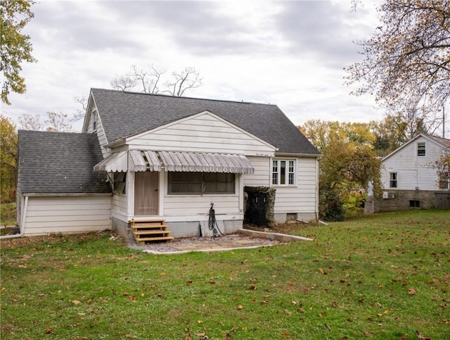 back of house with a lawn