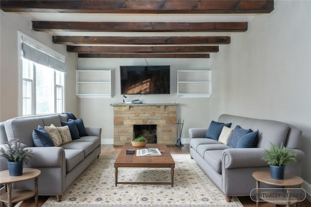 living room with beam ceiling, light hardwood / wood-style flooring, and a fireplace