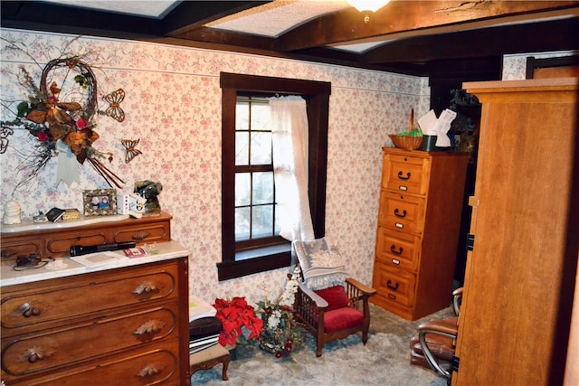 bedroom with light carpet and beam ceiling