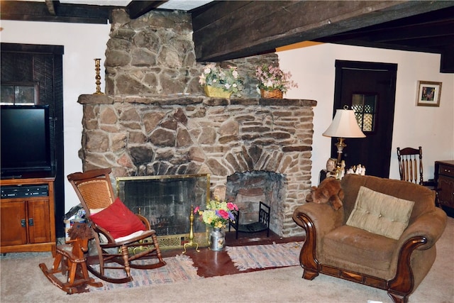 living room featuring carpet flooring, a stone fireplace, and beamed ceiling