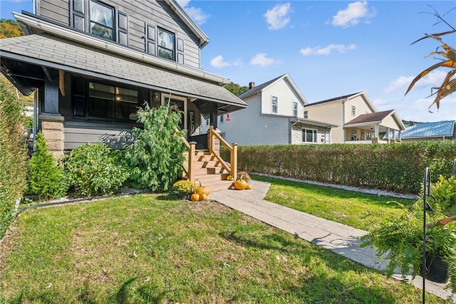 view of front of home with a front yard and a porch