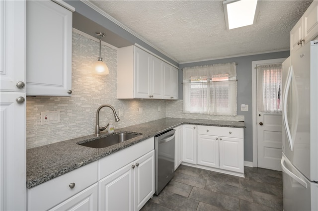 kitchen featuring sink, pendant lighting, stainless steel dishwasher, white cabinetry, and white fridge