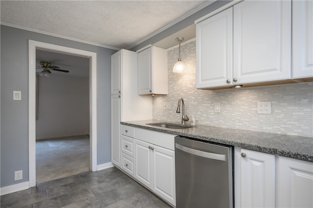 kitchen featuring sink, white cabinetry, stainless steel dishwasher, dark stone countertops, and ornamental molding