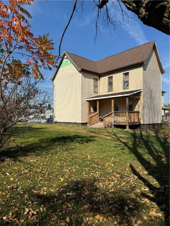 back of house with a yard and a deck