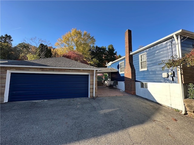 view of side of property with a garage