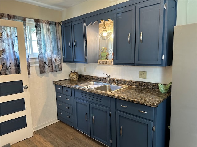 kitchen featuring blue cabinetry, sink, and dark hardwood / wood-style flooring