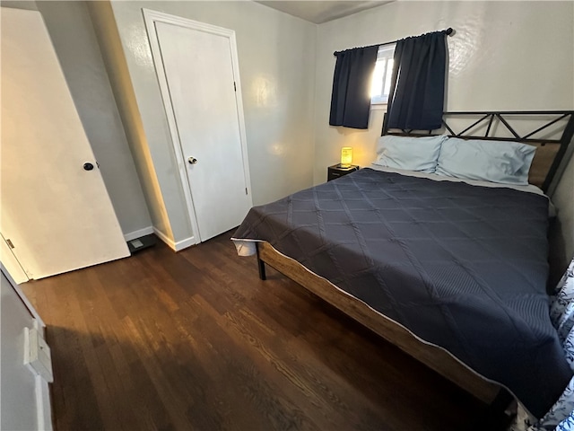 bedroom featuring a closet and dark hardwood / wood-style flooring