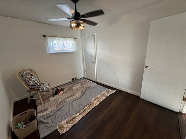 unfurnished bedroom featuring dark hardwood / wood-style flooring and ceiling fan