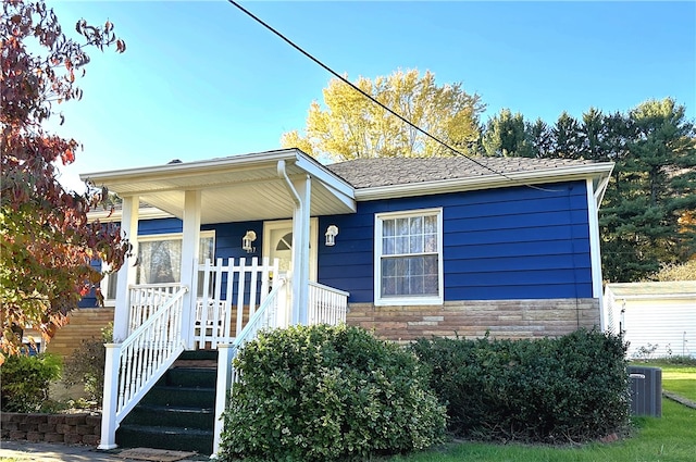 view of front of property with a porch and central AC unit