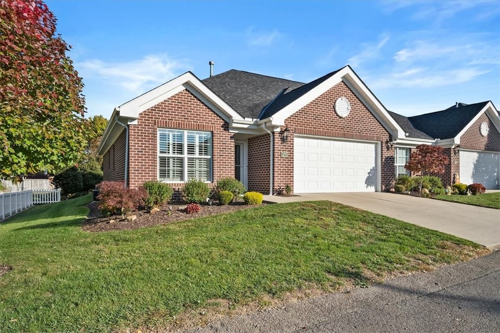 view of front facade with a front yard and a garage