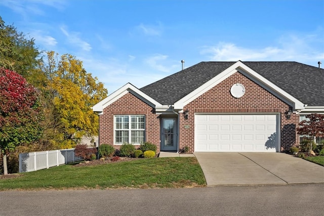 view of front of house featuring a front yard and a garage