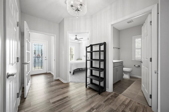 bathroom featuring toilet, a healthy amount of sunlight, vanity, and wood-type flooring