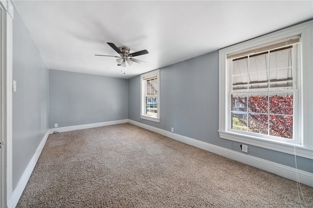 unfurnished room with ceiling fan, a healthy amount of sunlight, and carpet floors